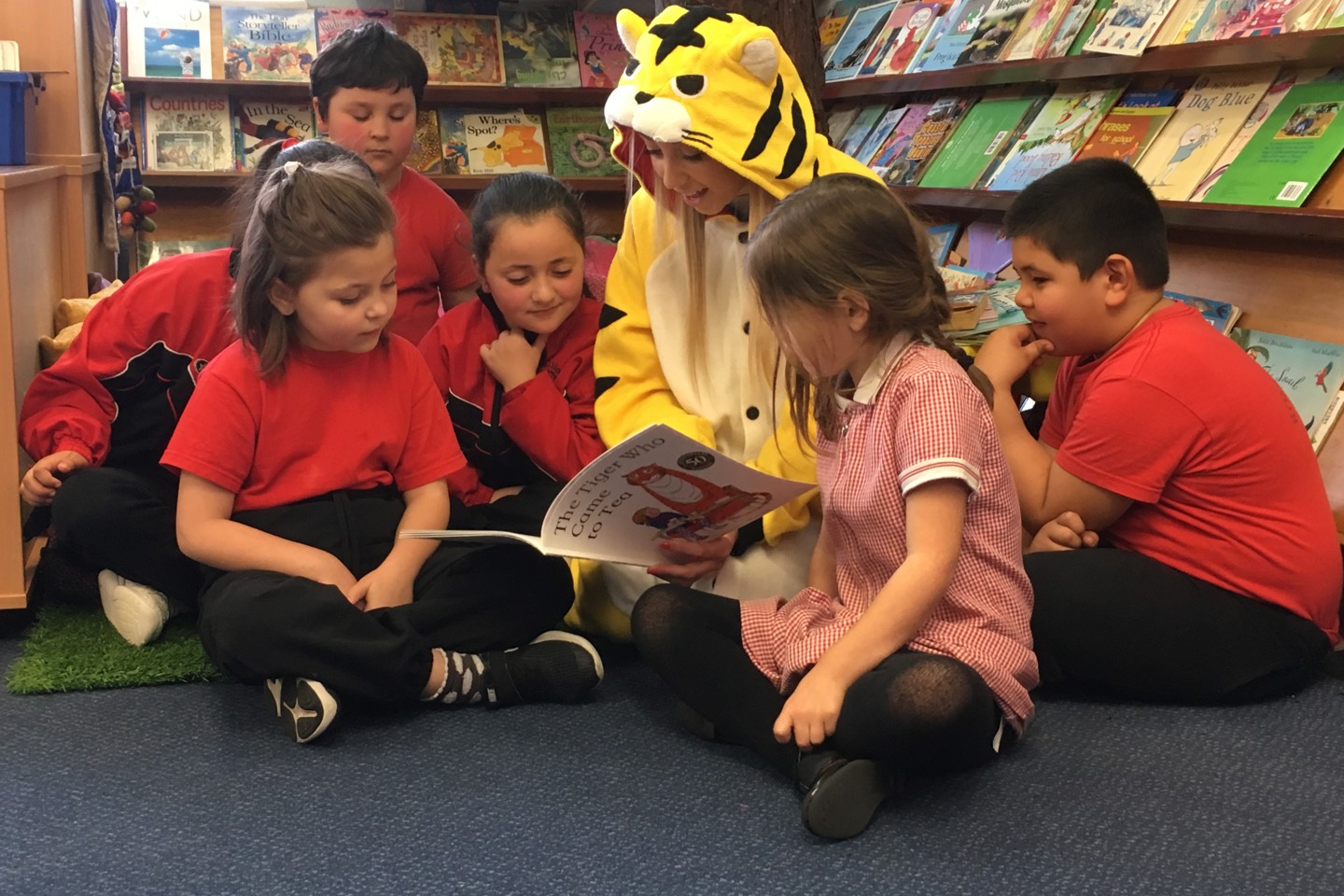 Photo of Ogier staff reading to school children