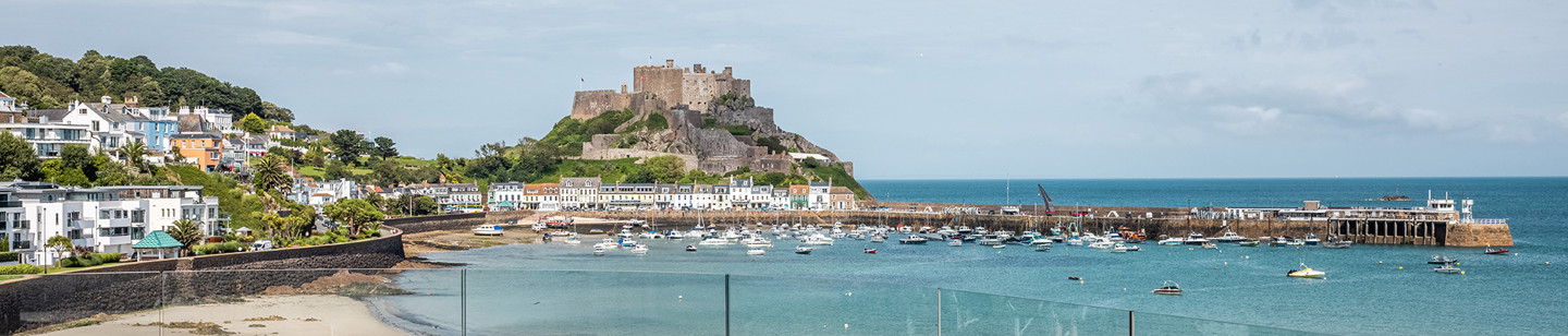 View from a balcony overlooking Gorey castle, the sea and the pier in Jersey