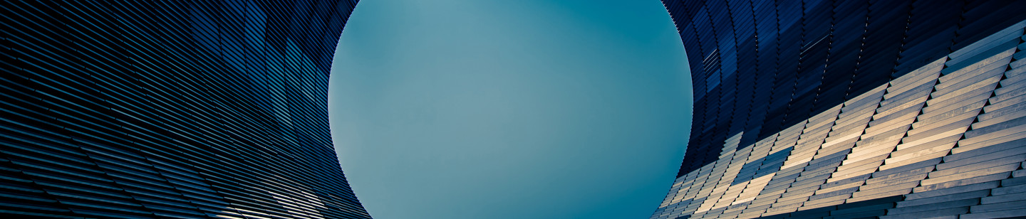 Circular engineered building pointing up towards sky