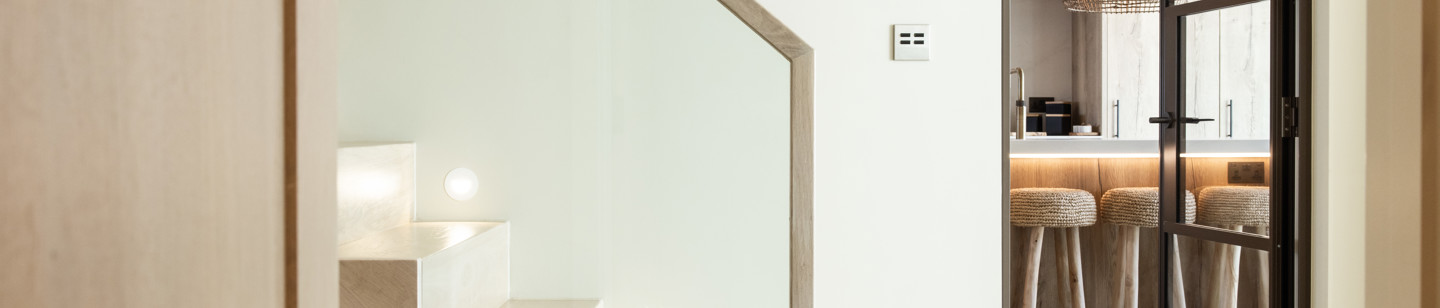 Interior shor of a house featuring a modern staircase and kitchen