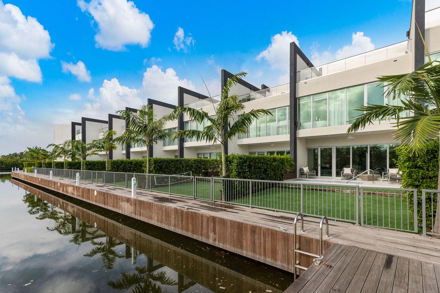 row of houses each one with a front garden and poolside 