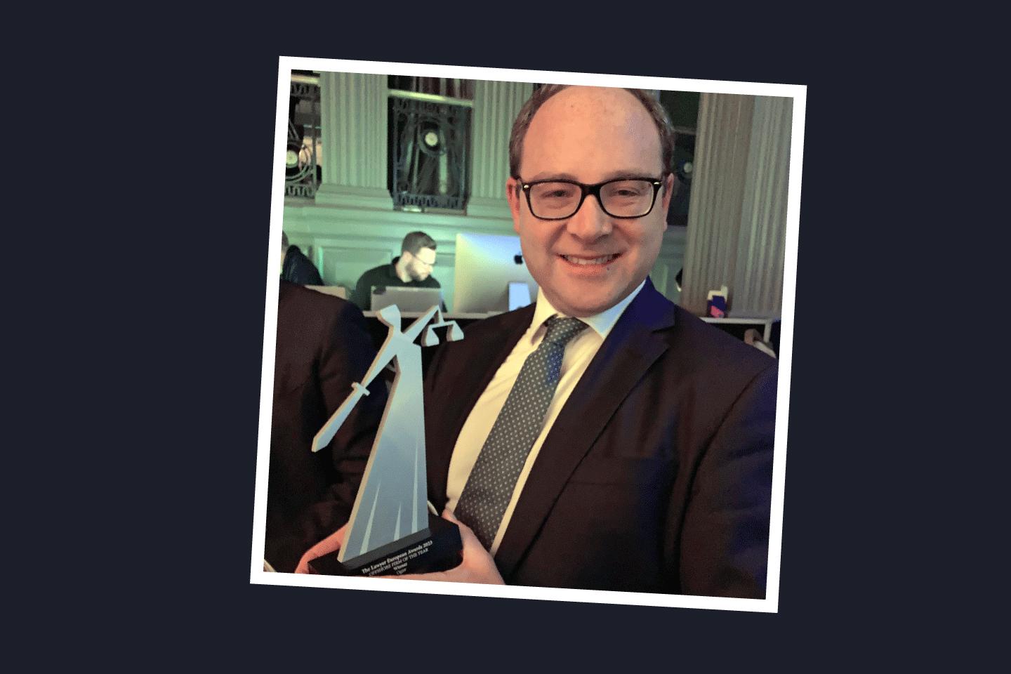 Person holding Offshore Law Firm of the Year trophy at awards ceremony in November 2023