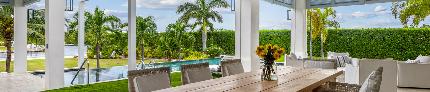 Eight seated table inside conservatory facing pool