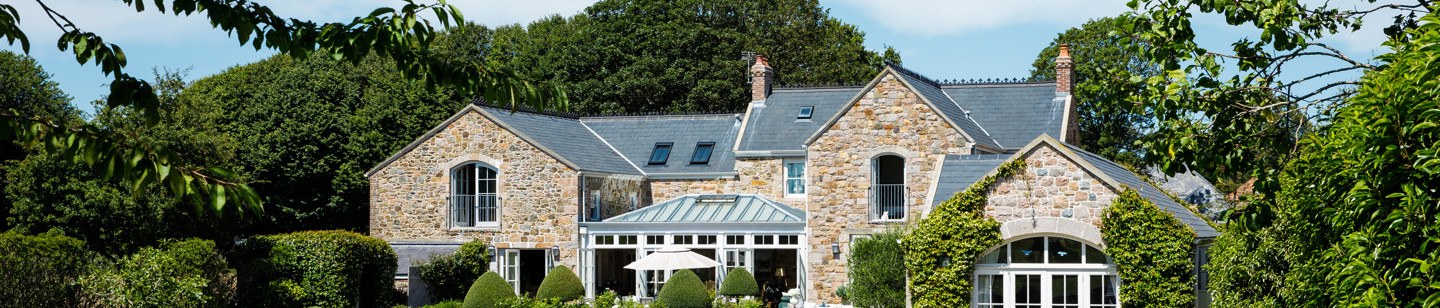 Converted countryside house with a swimming pool, a glass conservatory, and a landscaped garden Jersey