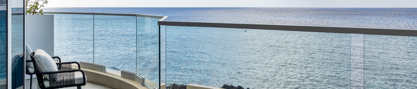 Balcony with chair on it with view of the sea 