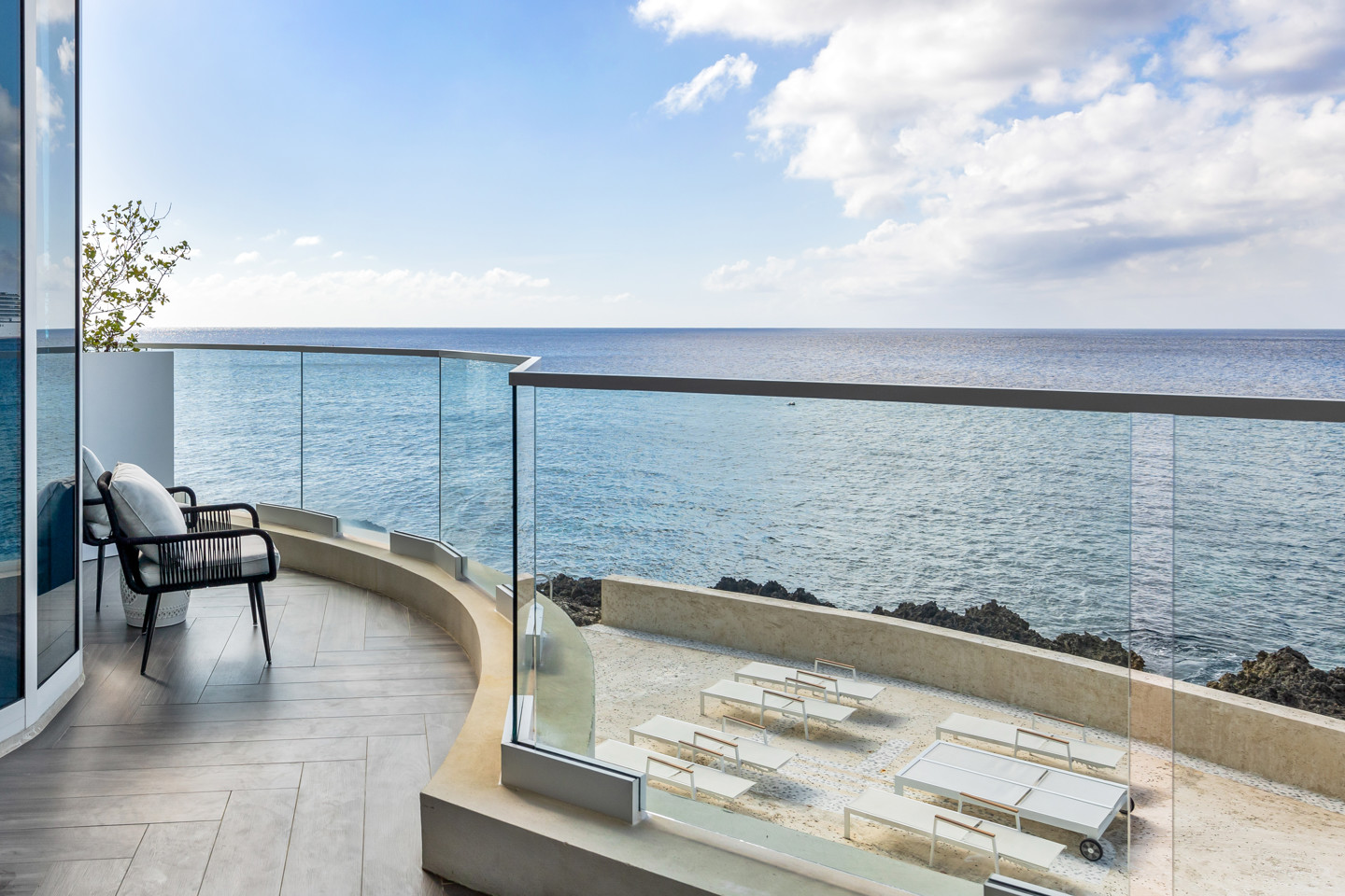 Balcony with chair on it with view of the sea 